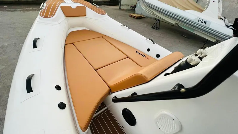 Slide: The Image of 2025 Aqvaboats Luxrib 22 with tan leather seating in a boatyard. - 27