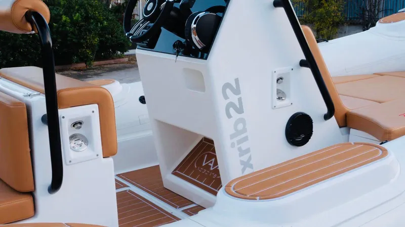 Slide: The Image of 2025 Aqvaboats Luxrib 22 interior with tan seats and modern controls. - 32