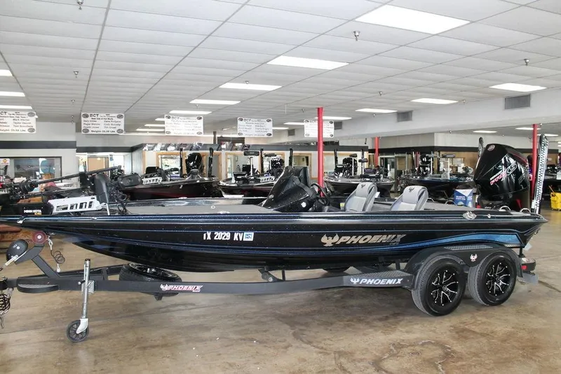 Slide: The Image of 2024 Phoenix 721 Pro XP boat displayed indoors on a trailer. - 1