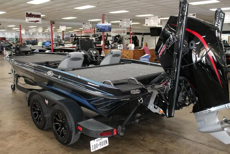 Slide: The Image of 2024 Phoenix 721 Pro XP boat displayed indoors with powerful engine and sleek design. - 2