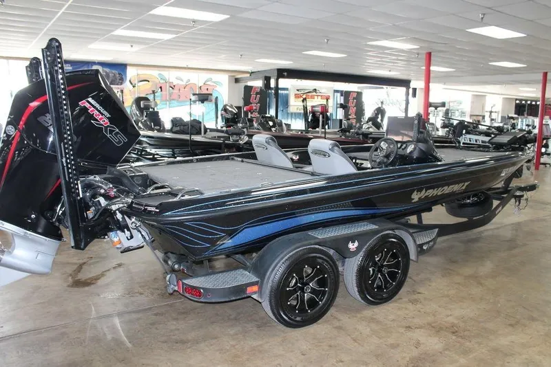 Slide: The Image of 2024 Phoenix 721 Pro XP bass boat in showroom, featuring sleek design and powerful engine. - 4