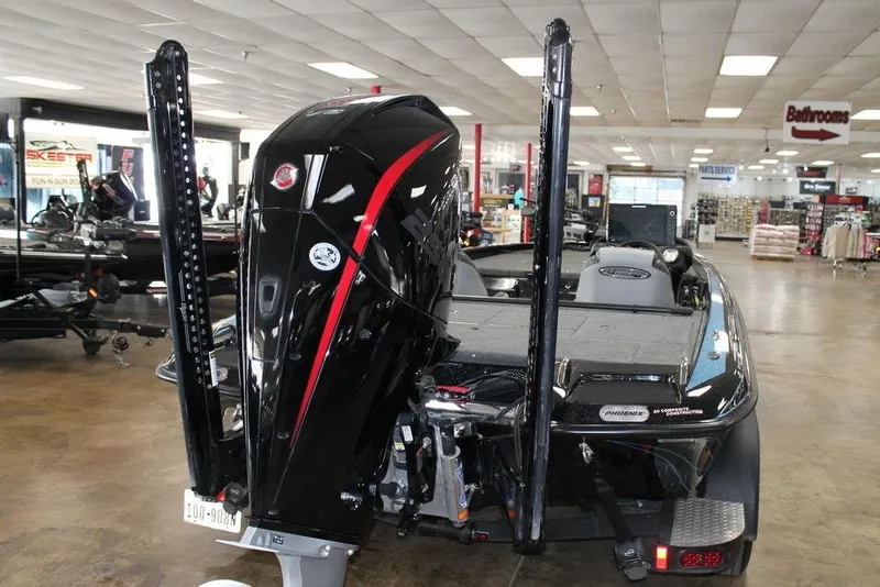 Slide: The Image of 2024 Phoenix 721 Pro XP boat displayed in showroom, rear view with powerful engine. - 7