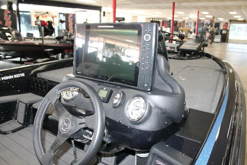 Slide: The Image of 2024 Phoenix 721 Pro XP boat dashboard with steering wheel and electronic display. - 9