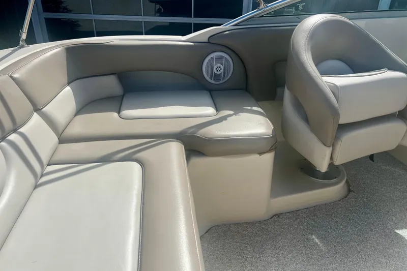 Slide: The Image of 2003 Searay 220 Sundeck interior with beige seating and speaker detail. - 12