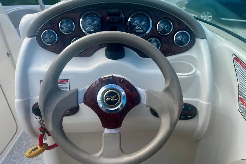 Slide: The Image of Steering wheel and dashboard of a 2003 Searay 220 Sundeck boat. - 15