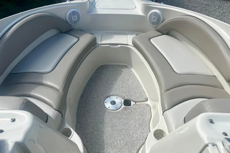 Slide: The Image of Interior of 2003 Searay 220 Sundeck boat with cushioned seating and speakers. - 16