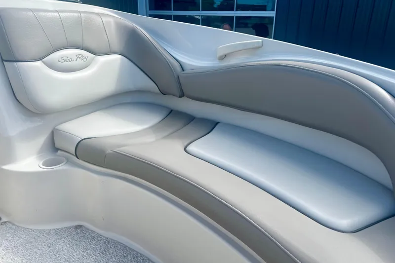 Slide: The Image of 2003 Searay 220 Sundeck boat interior with gray and white cushioned seating. - 17