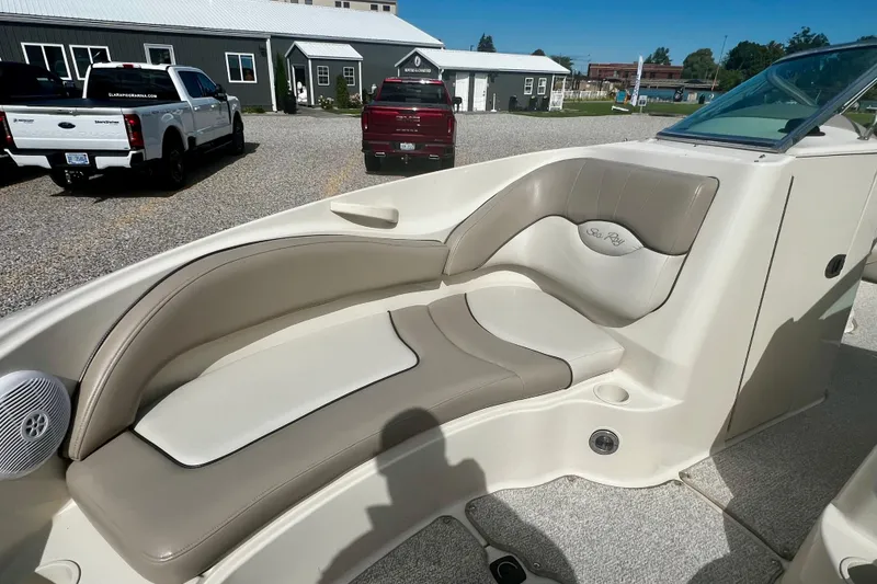 Slide: The Image of 2003 Searay 220 Sundeck boat interior with beige seating and cup holders. - 18