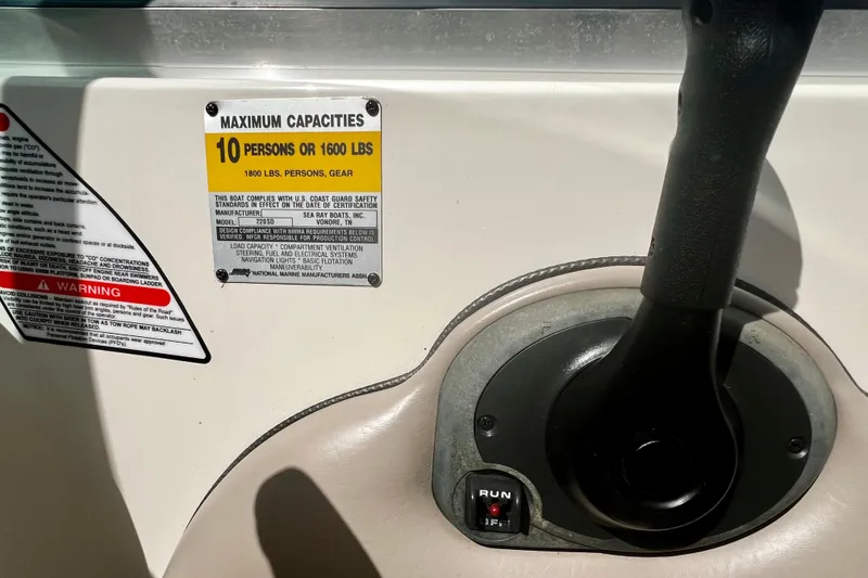 Slide: The Image of 2003 Searay 220 Sundeck control panel with capacity warning label, 10 persons or 1600 lbs. - 19