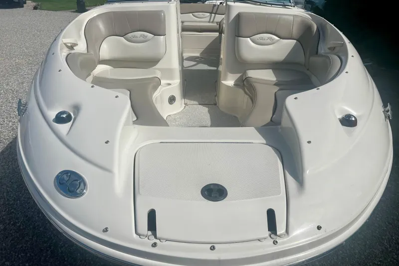Slide: The Image of 2003 Searay 220 Sundeck boat interior with seating and storage compartments. - 8