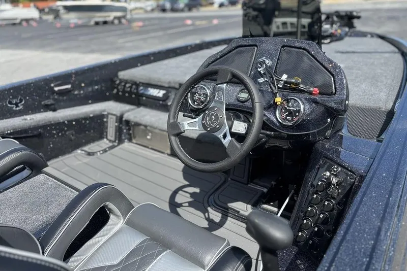 Slide: The Image of Interior of 2026 Phoenix 920 Elite X boat with modern dashboard and steering wheel. - 10