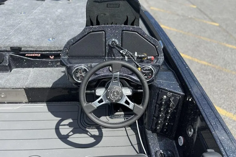 Slide: The Image of Steering console of 2026 Phoenix 920 Elite X boat with modern controls and dashboard. - 11