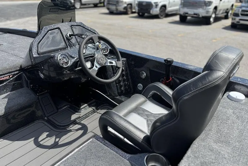 Slide: The Image of Interior of 2026 Phoenix 920 Elite X boat with steering wheel and seat. - 13