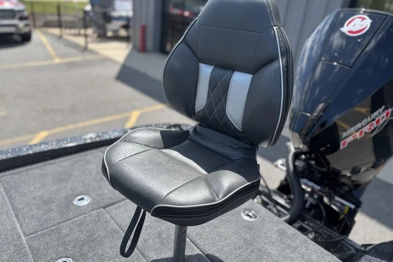 Slide: The Image of Black leather seat on a 2026 Phoenix 920 Elite X boat, with engine in background. - 24