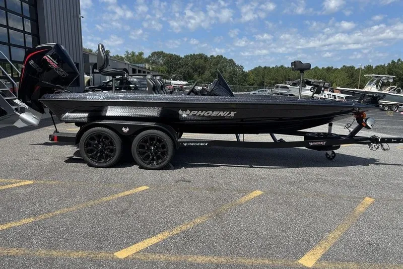 Slide: The Image of 2026 Phoenix 920 Elite X boat parked outdoors on a sunny day. - 6