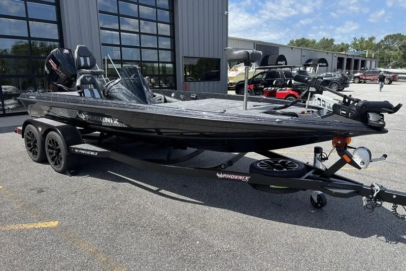 Slide: The Image of 2026 Phoenix 920 Elite X boat on trailer, parked outside a modern building. - 8