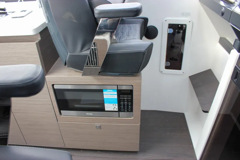 Slide: The Image of Interior of 2026 Wellcraft 38 Explorer featuring a microwave and seating area. - 24