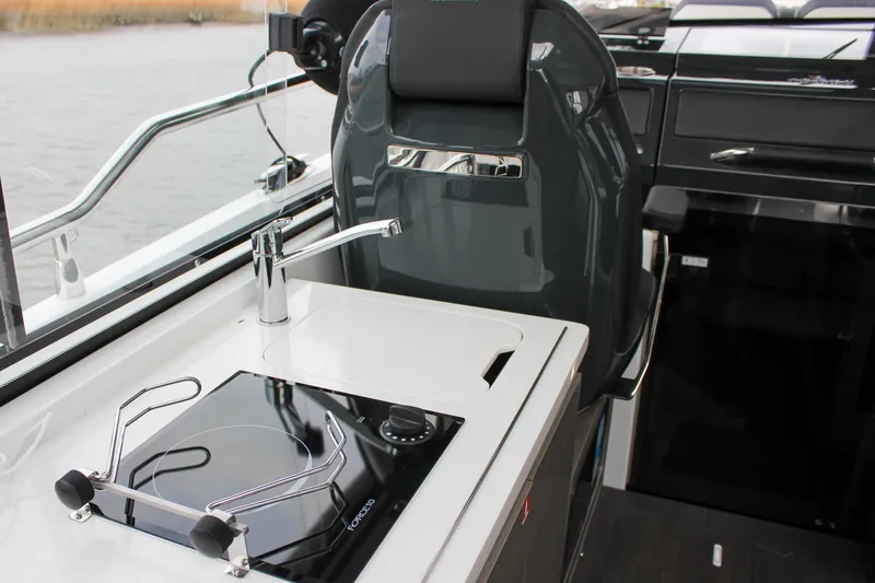 Slide: The Image of Modern kitchen area on 2026 Wellcraft 38 Explorer boat with stove and sink. - 26