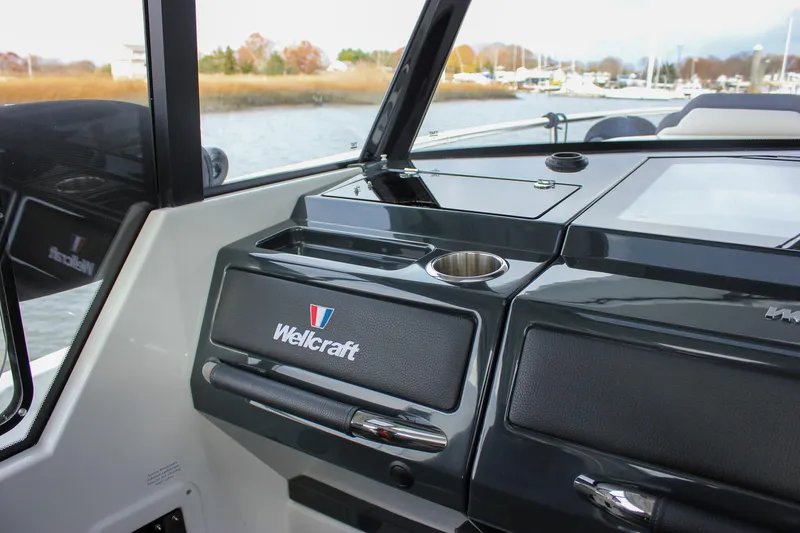 Slide: The Image of 2026 Wellcraft 38 Explorer boat interior with sleek dashboard and cup holder. - 31
