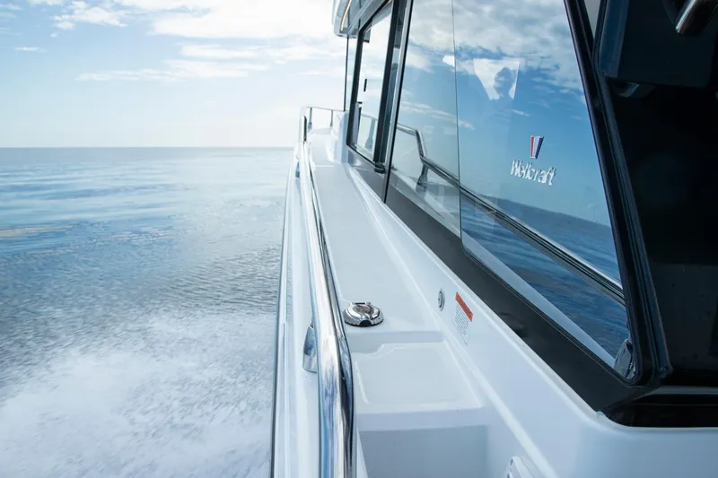 Slide: The Image of 2026 Wellcraft 38 Explorer boat docked between wooden piers. - 4