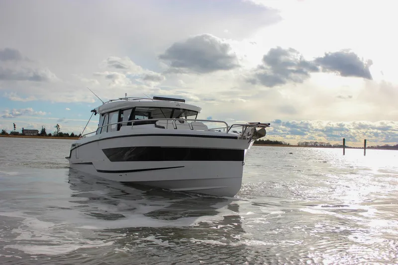 Slide: The Image of 2026 Wellcraft 38 Explorer boat on calm water under cloudy sky. - 44