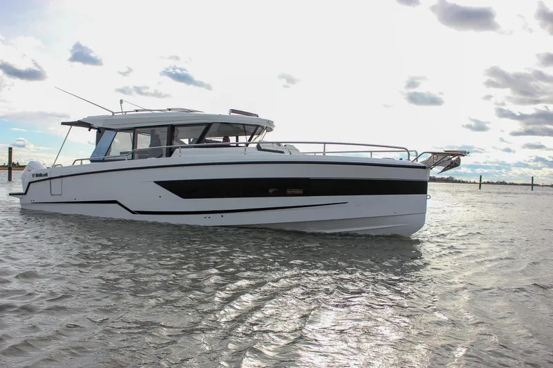 Slide: The Image of 2026 Wellcraft 38 Explorer boat on calm water under cloudy sky. - 45