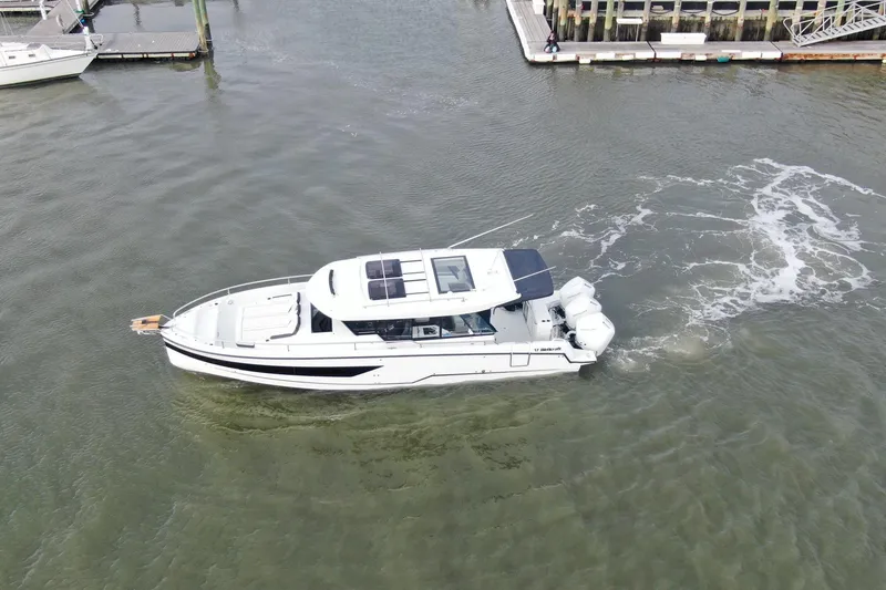 Slide: The Image of 2026 Wellcraft 38 Explorer boat cruising in marina waters, aerial view. - 51