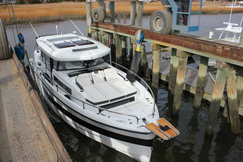 Slide: The Image of 2026 Wellcraft 38 Explorer docked at a marina, showcasing sleek design and modern features. - 52