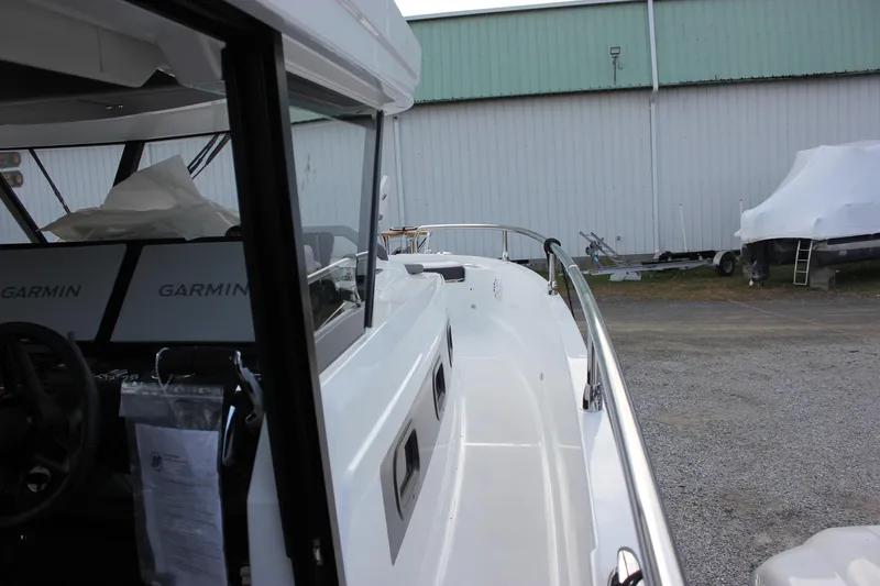 Slide: The Image of 2026 Wellcraft 38 Explorer boat with Garmin navigation, docked near a warehouse. - 53