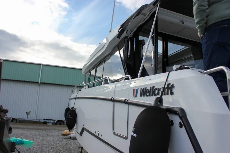 Slide: The Image of 2026 Wellcraft 38 Explorer boat docked, showcasing sleek design and modern features. - 56