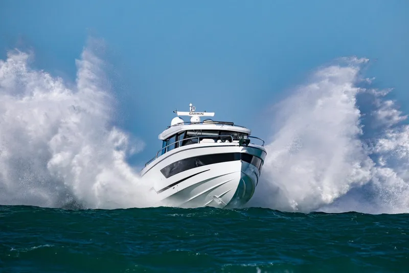 Slide: The Image of 2026 Wellcraft 38 Explorer boat navigating through ocean waves. - 62