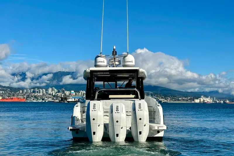 Slide: The Image of 2026 Wellcraft 38 Explorer boat with triple engines on scenic waterway. - 63