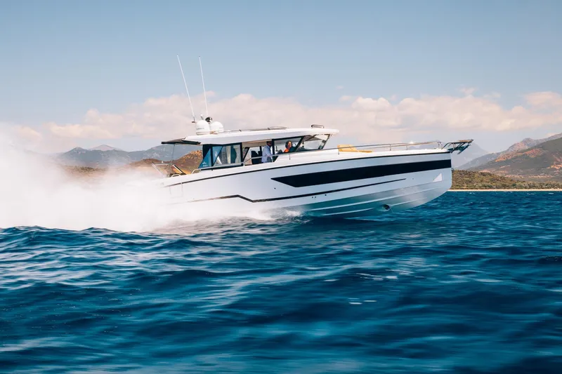 Slide: The Image of 2026 Wellcraft 38 Explorer speeding on open water, scenic mountain backdrop. - 67