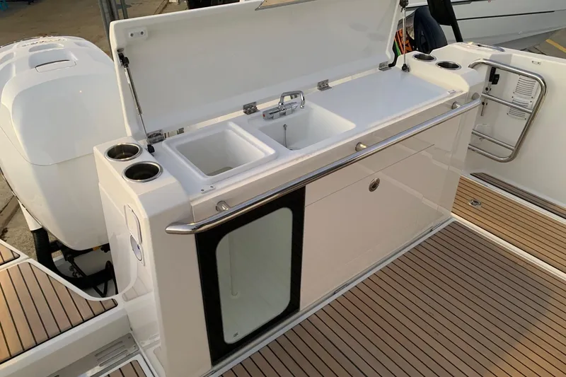 Slide: The Image of 2026 Wellcraft 38 Explorer boat cruising on water, showcasing sleek design and powerful engines. - 9