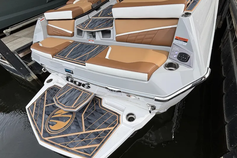 Slide: The Image of 2025 Tigé Ultré 25ZX boat interior with tan seating and modern design. - 10