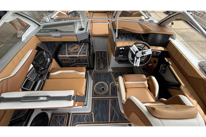 Slide: The Image of 2025 Tigé Ultré 25ZX boat interior with tan seating and modern design. - 11