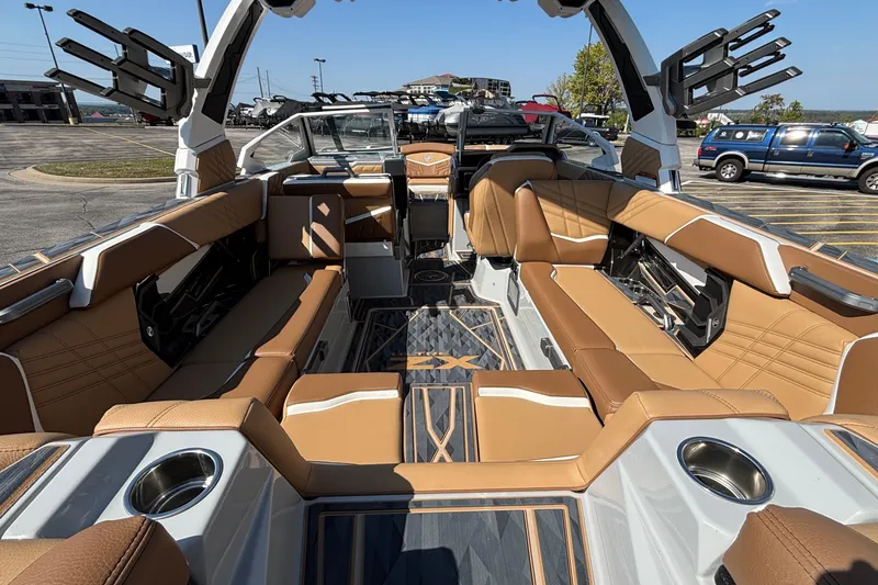 Slide: The Image of 2025 Tigé Ultré 25ZX boat interior with tan seating and modern design. - 12