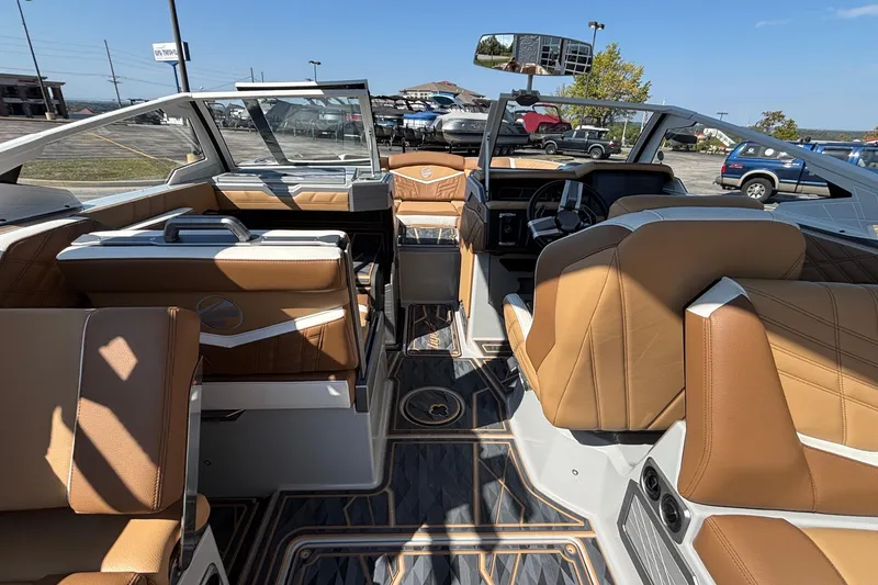 Slide: The Image of 2025 Tigé Ultré 25ZX boat interior with luxurious tan leather seating and modern dashboard. - 13