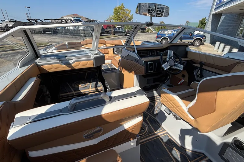 Slide: The Image of 2025 Tigé Ultré 25ZX boat interior with tan leather seats and modern dashboard. - 14