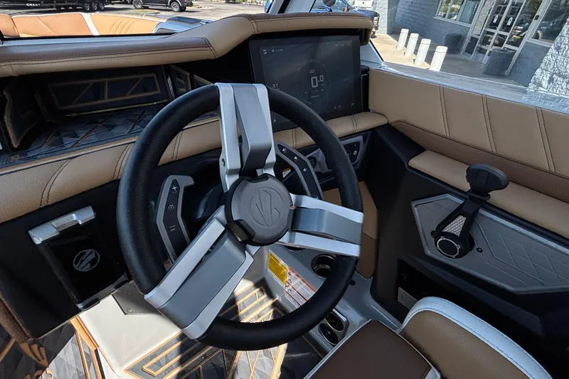Slide: The Image of Steering wheel and dashboard of 2025 Tigé Ultré 25ZX boat, featuring modern controls and design. - 20