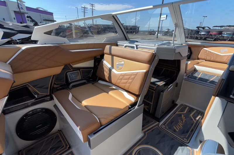 Slide: The Image of Interior of 2025 Tigé Ultré 25ZX boat with luxurious tan seating and modern design. - 24
