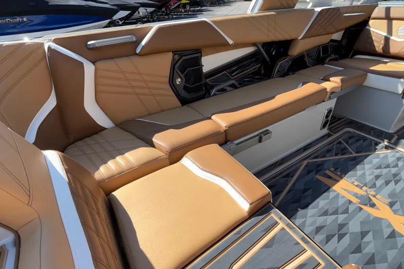 Slide: The Image of 2025 Tigé Ultré 25ZX boat interior with luxurious tan and white seating. - 25