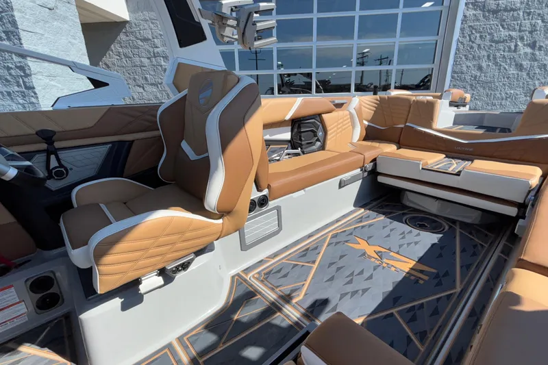 Slide: The Image of 2025 Tigé Ultré 25ZX boat interior with luxurious tan seating and modern design. - 26