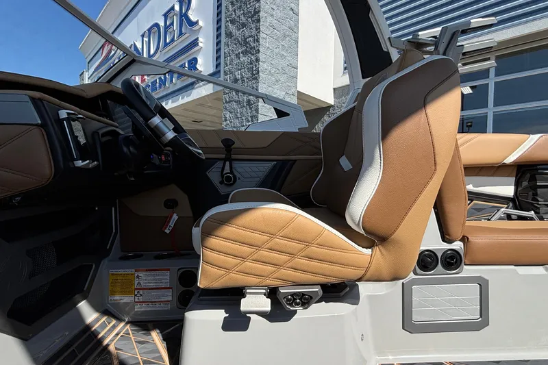 Slide: The Image of 2025 Tigé Ultré 25ZX boat interior with tan leather seats and modern dashboard. - 27