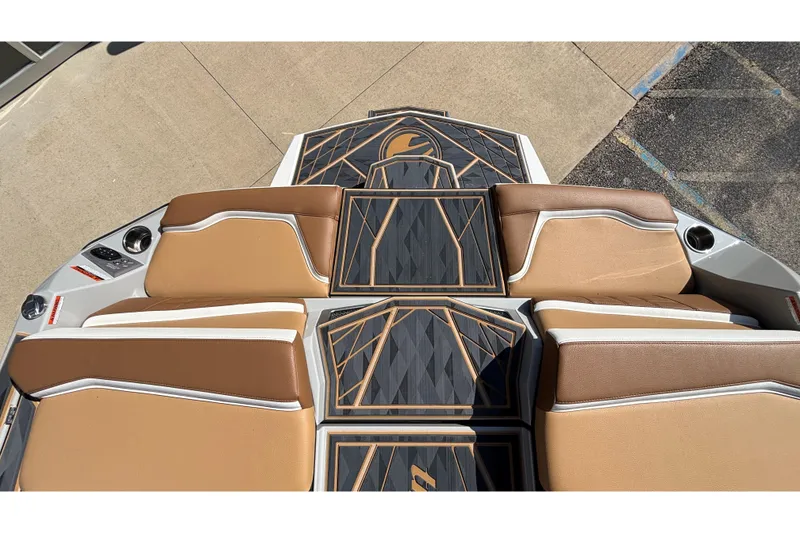 Slide: The Image of 2025 Tigé Ultré 25ZX boat interior with tan seats and geometric deck design. - 32
