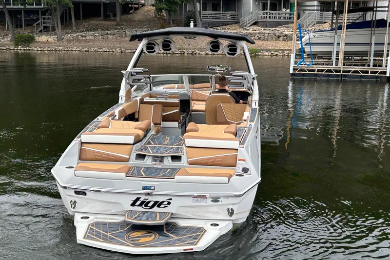 Slide: The Image of 2025 Tigé Ultré 25ZX boat with sleek design and modern features, parked outdoors. - 4