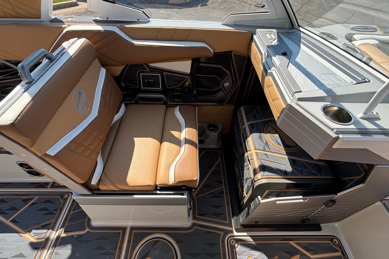 Slide: The Image of 2025 Tigé Ultré 25ZX boat interior with luxurious tan and gray seating, modern design. - 40