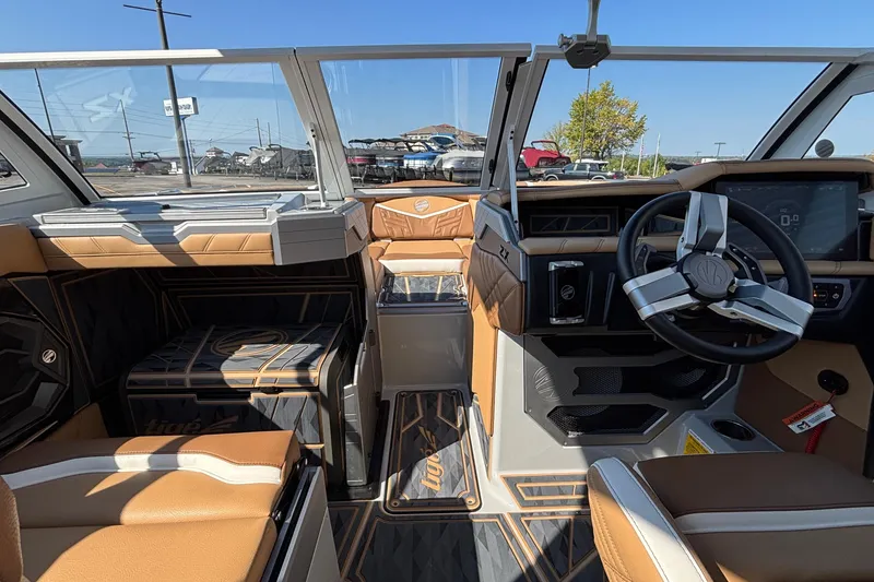 Slide: The Image of 2025 Tigé Ultré 25ZX boat interior with modern dashboard and luxurious seating. - 43
