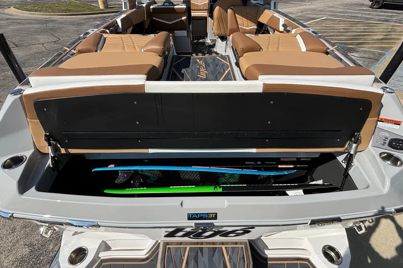 Slide: The Image of 2025 Tigé Ultré 25ZX boat with open storage compartment, showcasing sleek interior design. - 55