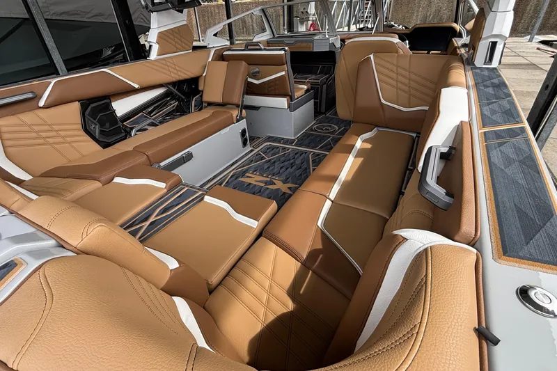 Slide: The Image of 2025 Tigé Ultré 25ZX boat interior with tan and white seating, modern design, and TAPS 3T technology. - 9
